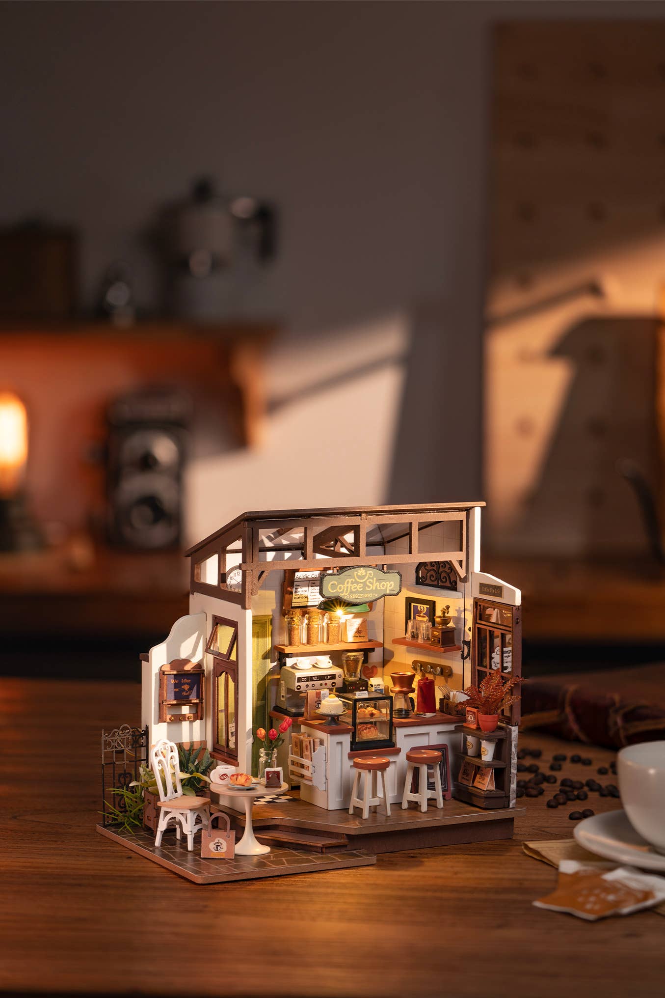 Mellow Monkey Slow Life Café DIY miniature house kit with warm interior lighting and detailed bistro furniture.