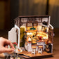 Mellow Monkey Slow Life Café DIY miniature house kit with detailed bistro interior, furniture, and warm lighting.