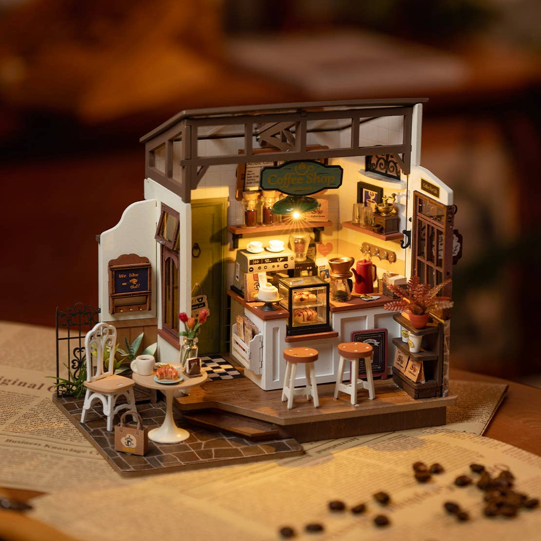 Mellow Monkey Slow Life Café DIY miniature house kit with warm interior lighting and detailed bistro furniture.