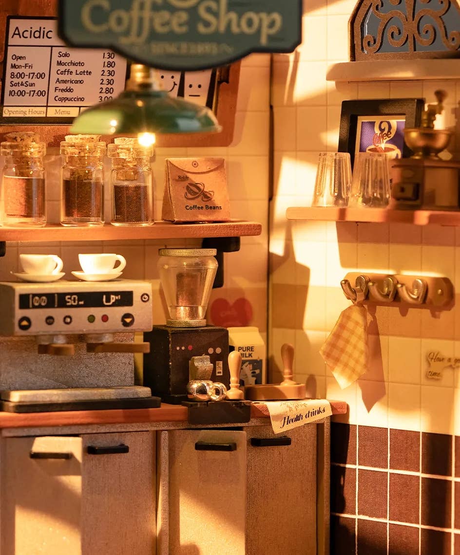 Mellow Monkey Slow Life Café DIY miniature house kit featuring a detailed coffee shop interior with warm lighting.