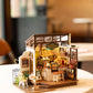 Mellow Monkey Slow Life Café DIY miniature coffee shop model kit with detailed furniture and warm lighting.