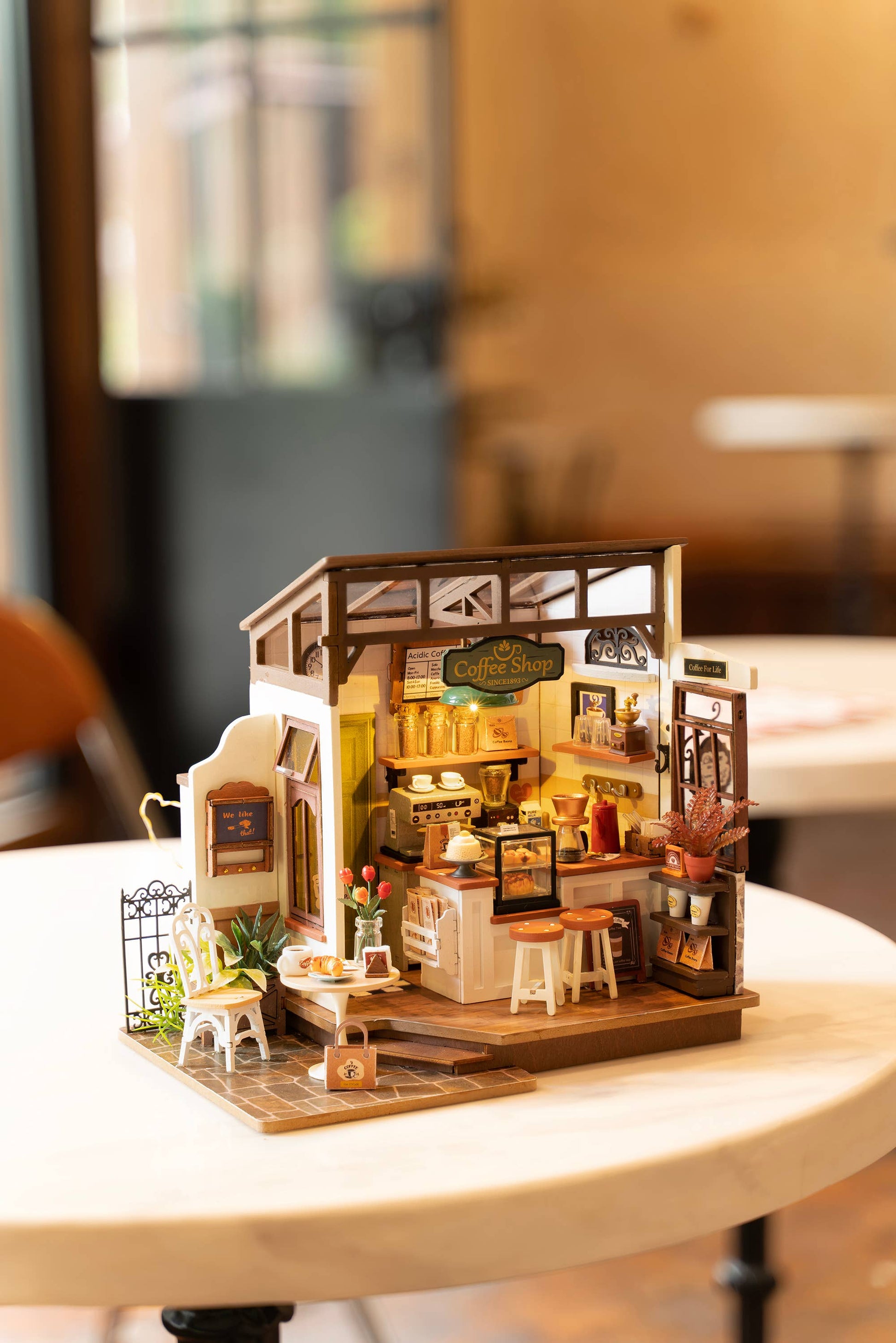 Mellow Monkey Slow Life Café DIY miniature coffee shop model kit with detailed furniture and warm lighting.