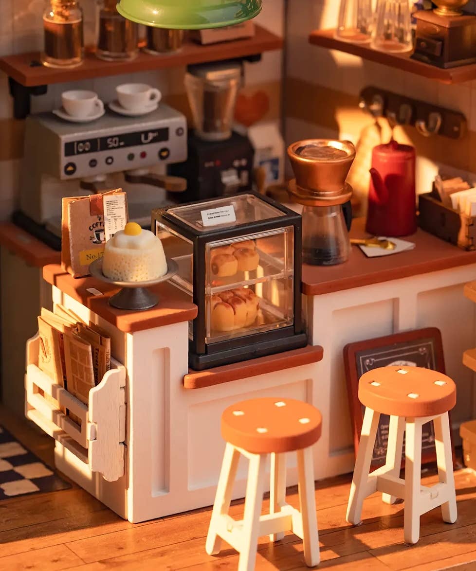 Mellow Monkey Slow Life Café DIY miniature house kit featuring a detailed coffee shop counter with stools and pastries