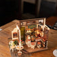 Mellow Monkey Slow Life Café DIY miniature house kit with detailed coffee shop furniture and decor on a wooden table.