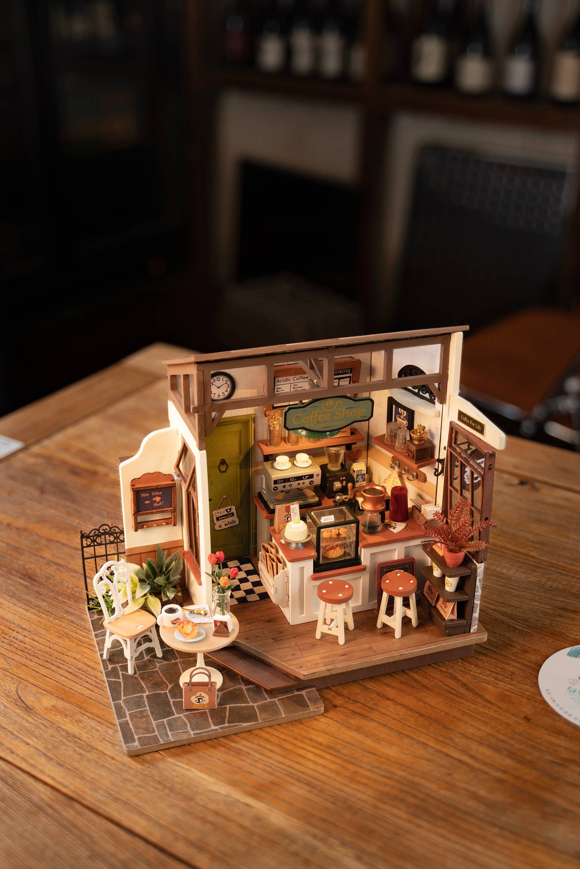 Mellow Monkey Slow Life Café DIY miniature house kit with detailed coffee shop furniture and decor on a wooden table.