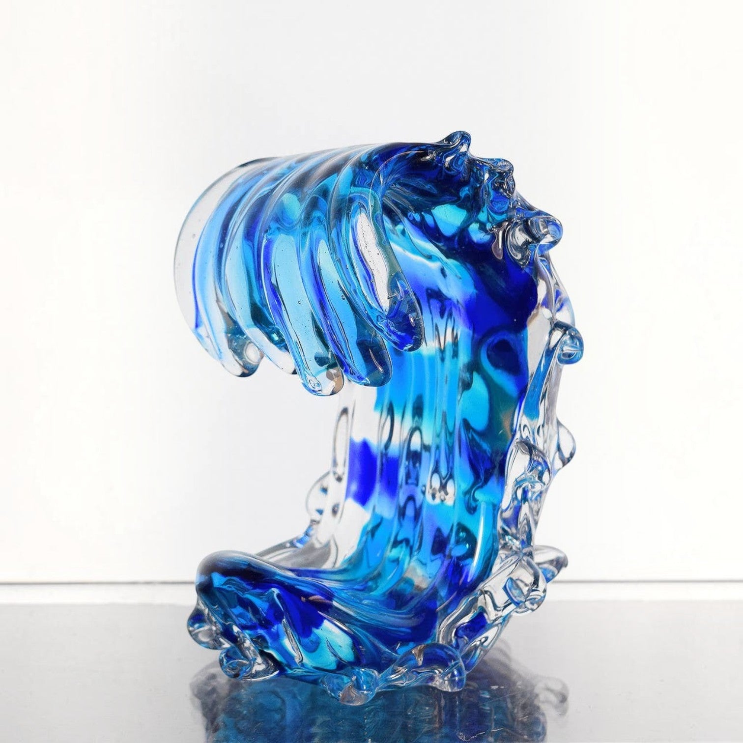 Mellow Monkey Small Sized Wave glass sculpture featuring swirling blue and clear ocean wave design for coastal decor.