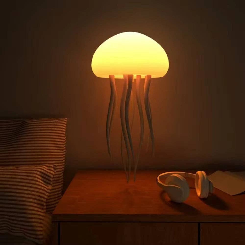 Mellow Monkey rechargeable RGB smart jellyfish night light with glowing dome and flexible tentacles on a bedside table