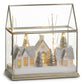 Mellow Monkey Snow City lighted terrarium with glittery houses, pine trees, and warm LED lights in a glass display.
