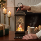 Mellow Monkey 11-inch black musical water lantern with a snowman, swirling glitter, and festive holiday lighting.