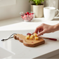 Mellow Monkey snowman-shaped wooden mini serve board with cheese cubes on a white kitchen counter