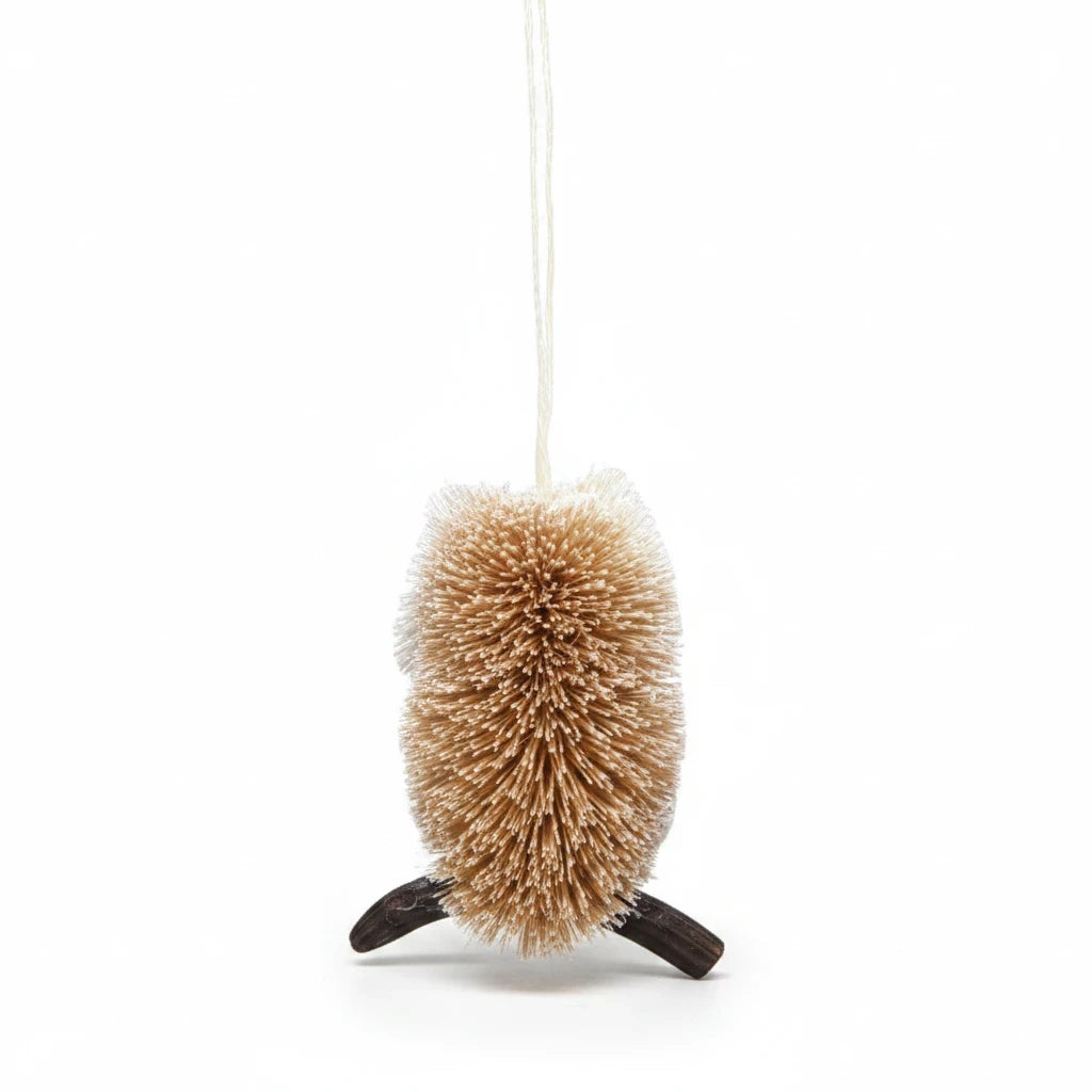 Mellow Monkey 4-inch snowy owl holiday ornament made from natural bottle brush fibers with a dark wood branch perch.
