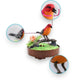 Mellow Monkey sound-activated red singing bird toy on a branch with interactive head and wing movement features