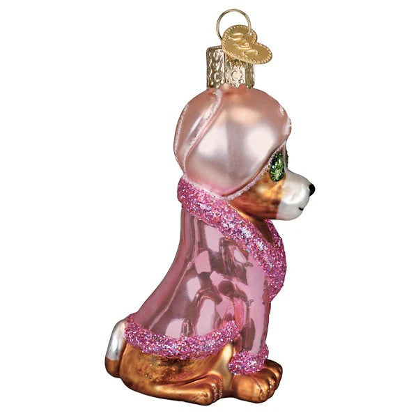 Mellow Monkey Spa Dog blown glass holiday ornament, pink robe with glitter trim, green gem eyes, sitting pose.