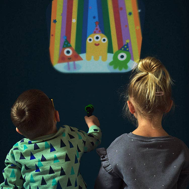 Two children using a Mellow Monkey space-themed storybook flashlight to project an alien party scene on a wall.