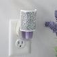 Mellow Monkey Sparkle WallScents fragrance warmer featuring a decorative silver rhinestone cover in a wall outlet.