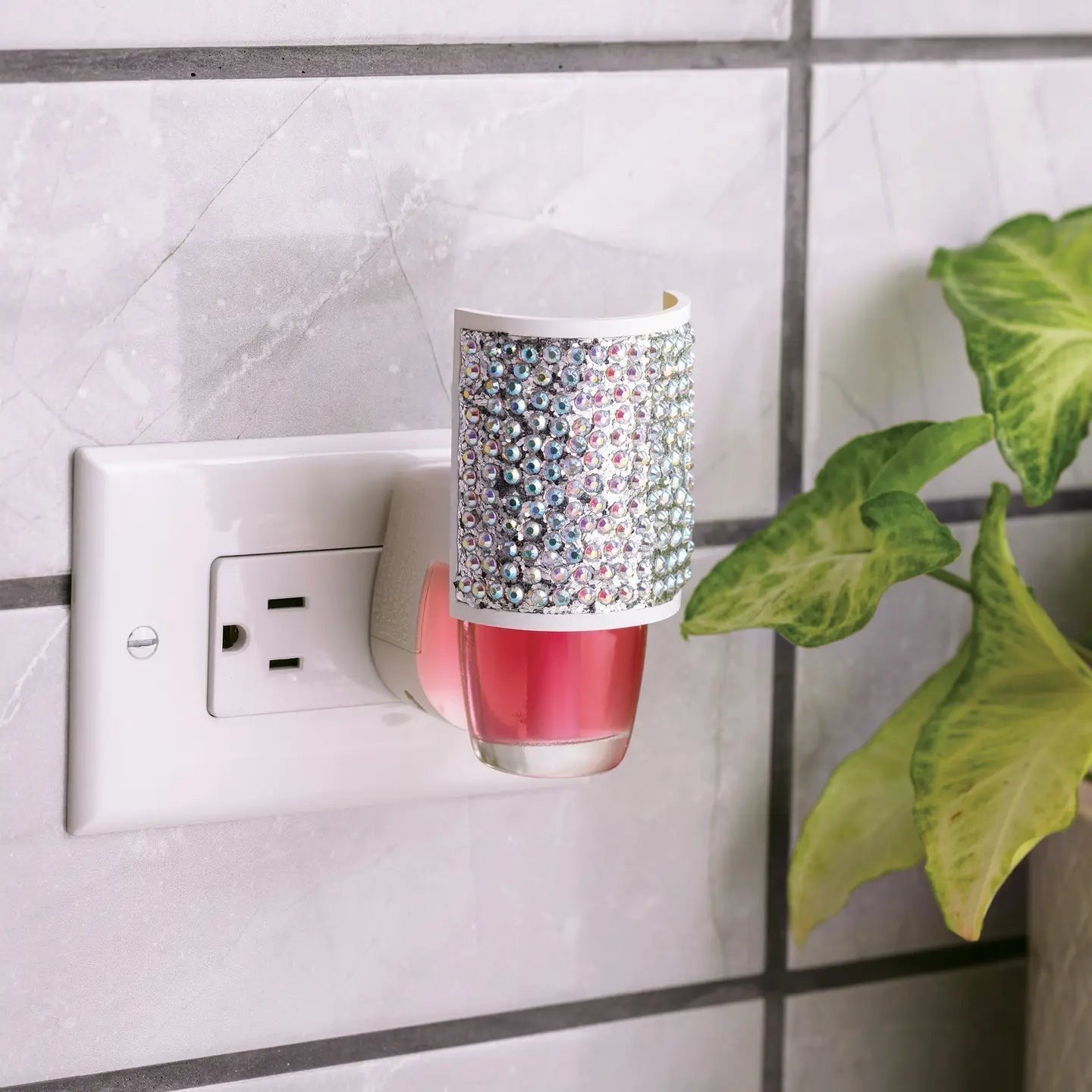 Mellow Monkey Sparkle WallScents fragrance warmer featuring a decorative rhinestone cover plugged into a wall outlet.