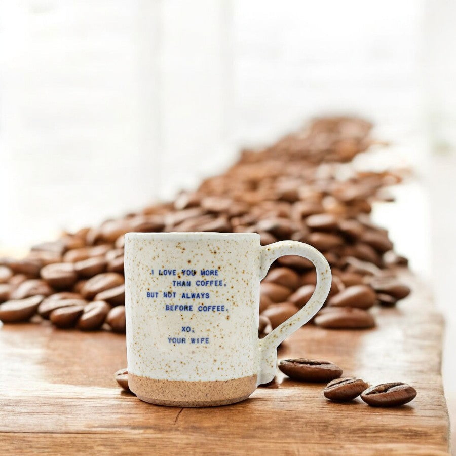 Mellow Monkey handmade ceramic mug with speckled finish and I love you more than coffee quote on a wooden surface