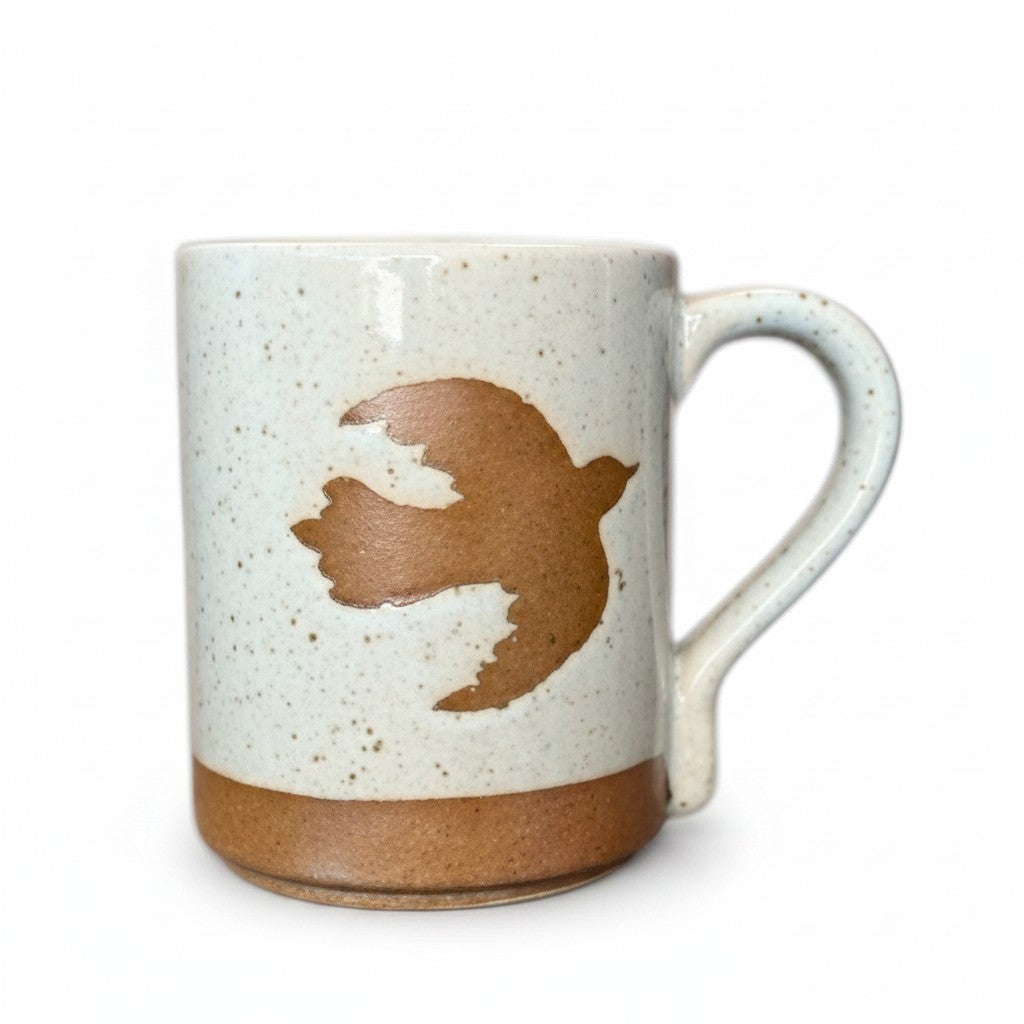 Mellow Monkey speckled stoneware mug featuring a hand-carved brown bird design on a cream background