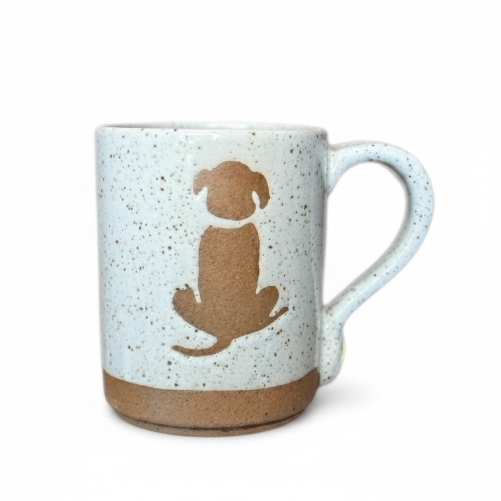 Mellow Monkey speckled stoneware mug featuring a hand-carved brown dog silhouette on a light cream background