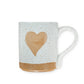 Mellow Monkey speckled stoneware mug featuring a hand-carved tan heart design on a cream background