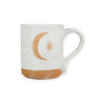 Mellow Monkey speckled stoneware mug featuring a hand-carved moon and star design with a natural clay base.