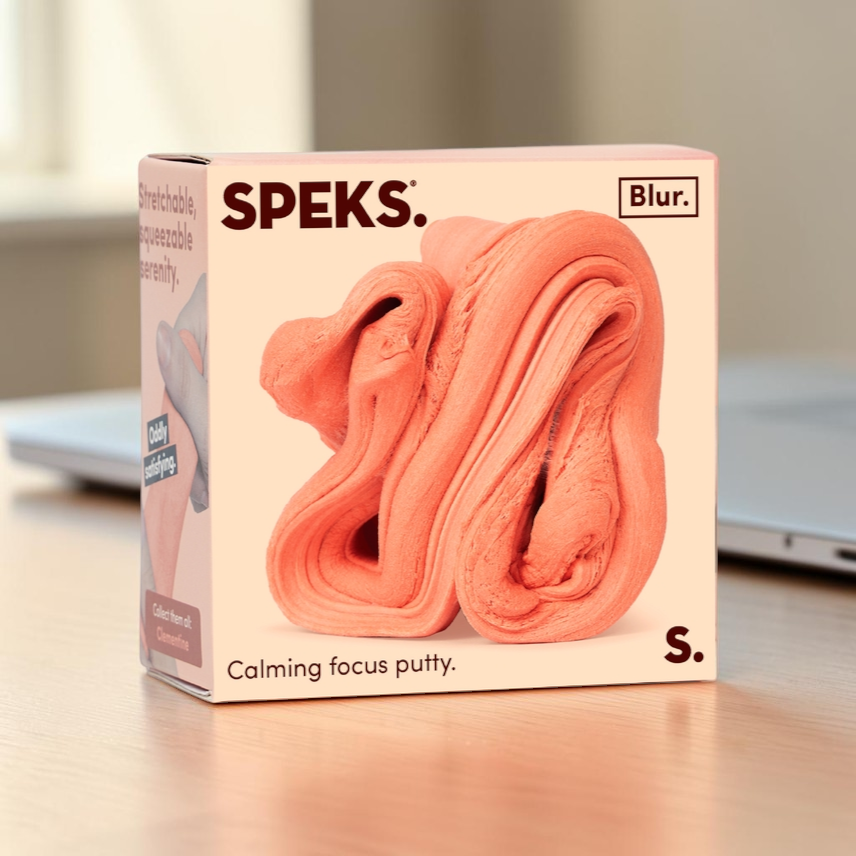 Mellow Monkey Speks Blur focus putty in Clementine orange, a soft and stretchable sensory stress relief toy in a box.