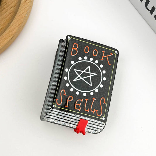 Mellow Monkey black spell book hair claw clip with white pentagram and red bookmark detail