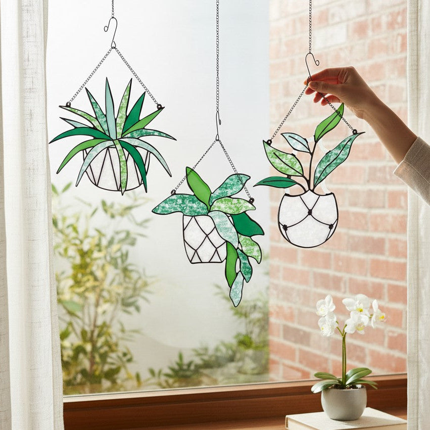Mellow Monkey stained glass succulent suncatchers in hanging pots displayed in a window