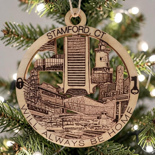 Mellow Monkey 4-inch round wooden ornament featuring laser-engraved Stamford CT landmarks on a Christmas tree.