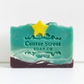 Mellow Monkey handmade Starry Night artisan soap bar with teal swirl, dark base, and a yellow star accent
