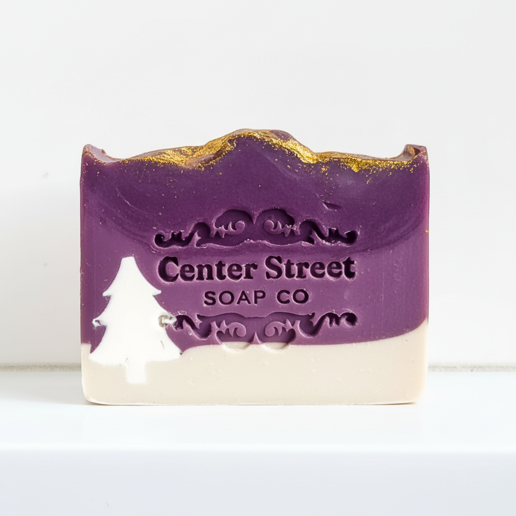 Mellow Monkey Starry Night artisan soap bar with purple and white layers, gold glitter, and a white pine tree design.