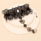 Mellow Monkey steampunk lace hand bracelet with skull cameo, bronze gears, and charms on a beige display stand.