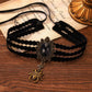 Mellow Monkey black velvet choker necklace with a vintage bronze spider pendant and faceted oval gemstone center.