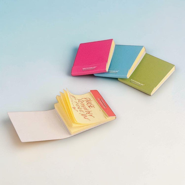 Mellow Monkey sticky note matchbooks in pink, blue, green, and orange with a handwritten note on yellow paper.