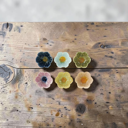 Mellow Monkey set of six colorful stoneware flower-shaped bowls with reactive glaze in various pastel and bold hues.