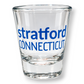 Mellow Monkey clear glass shot glass featuring blue Stratford Connecticut text, perfect for a souvenir or bar display.