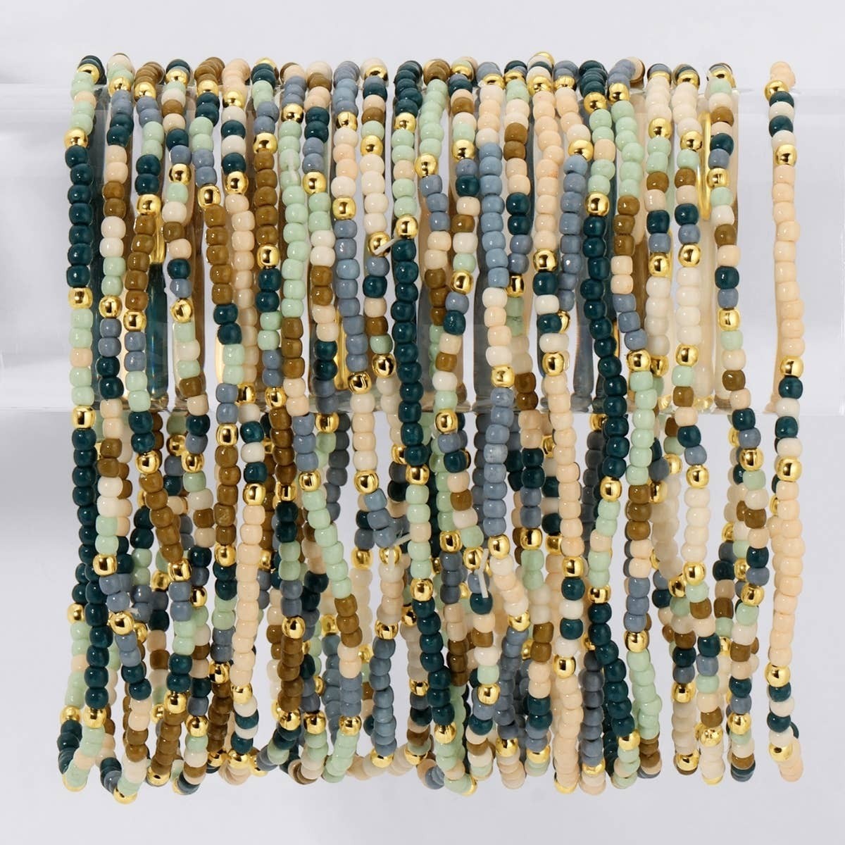 Mellow Monkey stretch seed bead bracelets in olive brown, ivory, and blue with 18k gold-plated brass accents.