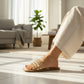 Mellow Monkey studded clear strap slide sandals with gold studs and a tan sole. A woman's foot wearing the sandals and an anklet.
