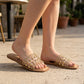 Mellow Monkey tan flat slide sandals with clear straps adorned with gold studs.
