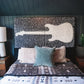 Mellow Monkey Sugarboo Legends two-piece guitar wall art with music lyrics on a black background above a bed