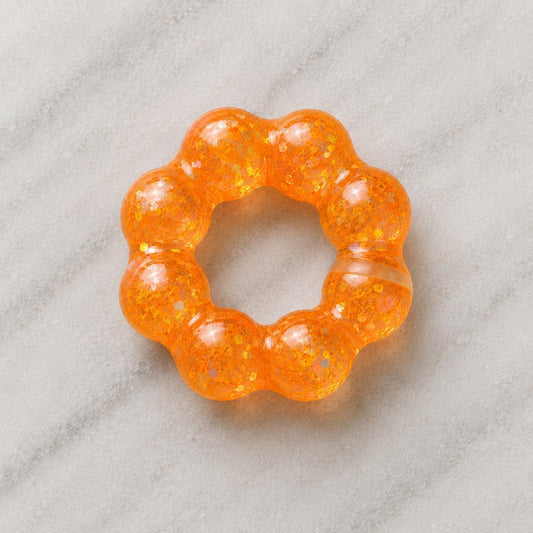 Mellow Monkey Sunburst Orange Feelzies Original sensory bracelet with glittery, squishy, donut-shaped design.