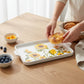 Mellow Monkey rectangular stoneware sunflower platter being used to serve a pastry on a wooden table.