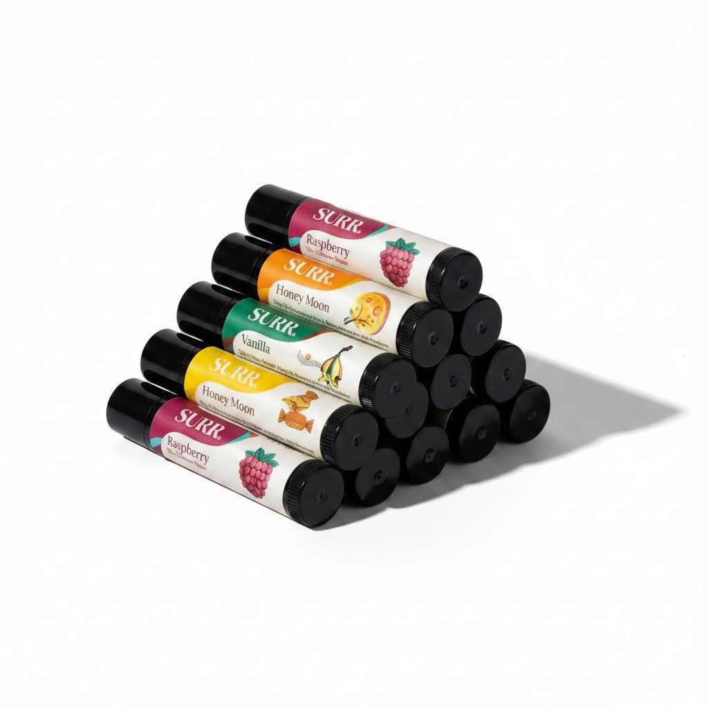 Mellow Monkey SURR Silk Ultra lip balms in a 24-pack display box, featuring Raspberry, Honey Moon, Vanilla, Toffee, Orange, and Caramel flavors.