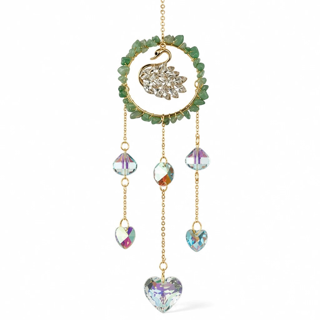 Mellow Monkey swan suncatcher with green healing stones, gold chains, and iridescent crystal hearts and prisms.
