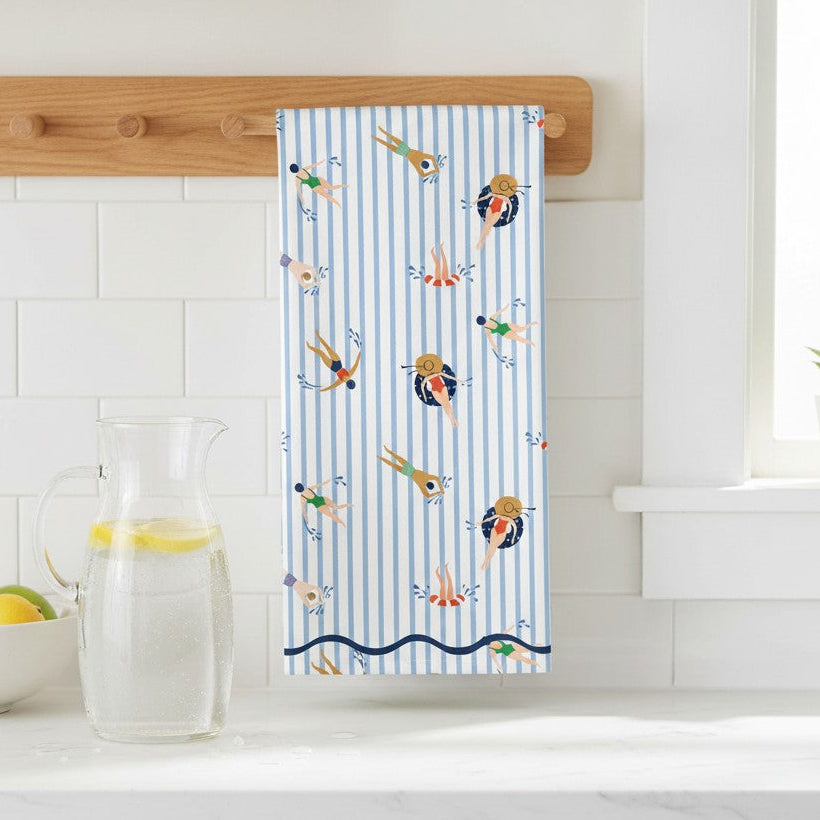 Mellow Monkey 100% cotton tea towel with blue and white stripes and a playful swimmer pattern.