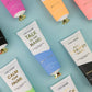 Mellow Monkey Talk to the Hand cypress and juniper scented moisturizing hand cream in a white tube with a gold cap.