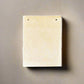 Mellow Monkey tan leather notepad with off-white tree-free paper, 6x4.5 inches, string tie closure.