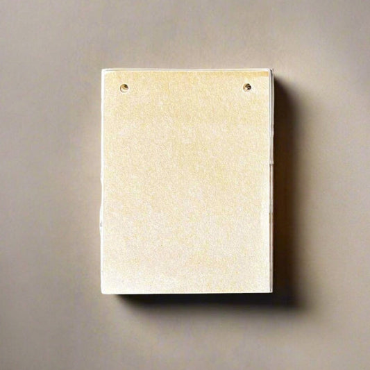 Mellow Monkey tan leather notepad with off-white tree-free paper, 6x4.5 inches, string tie closure.