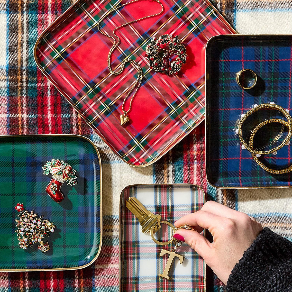 Mellow Monkey decorative metal trays in assorted tartan plaid patterns holding holiday jewelry and keys