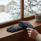 Mellow Monkey red and black tartan plaid winter gloves with microsuede palms resting on a snowy windowsill.